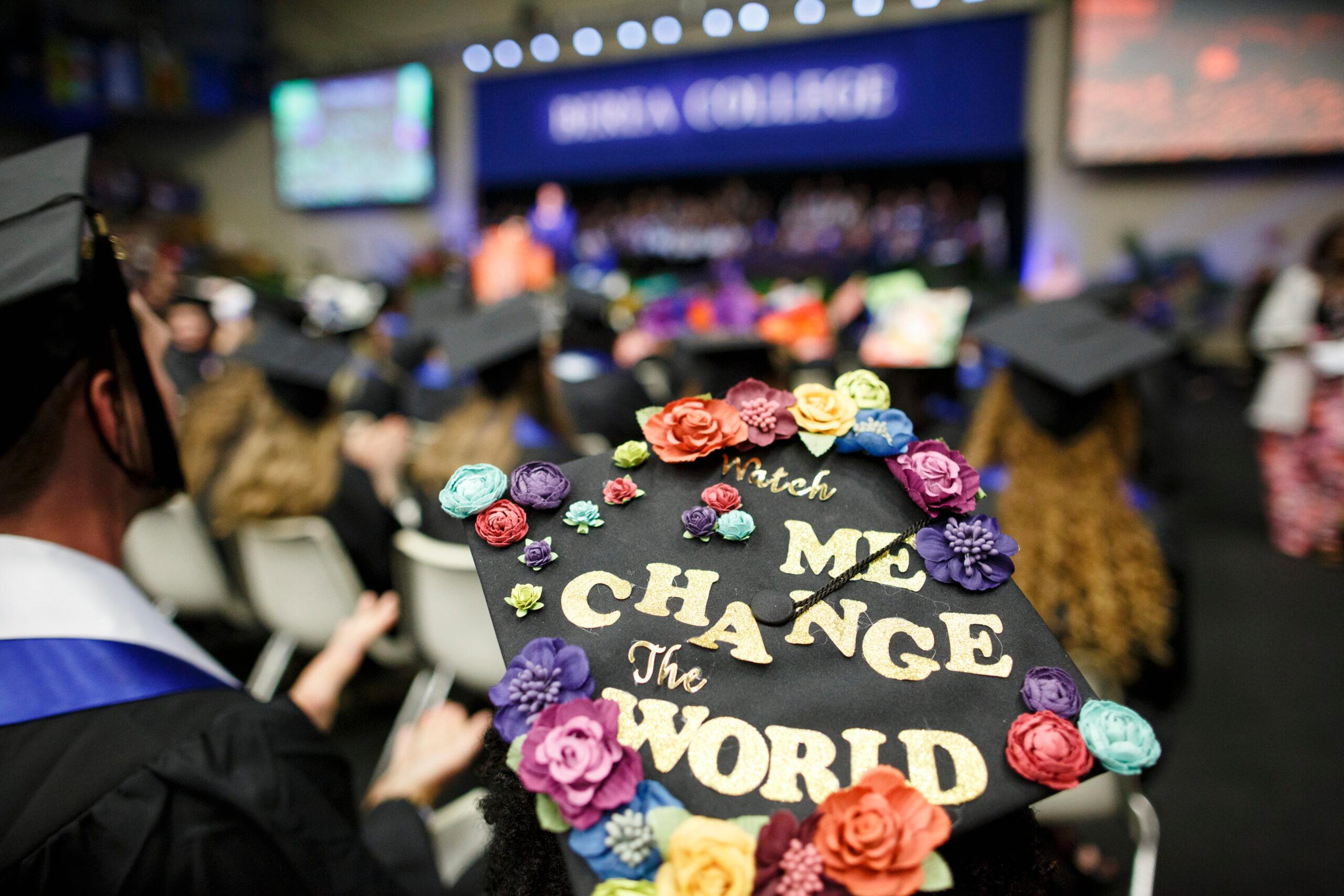 Decorated Graduation cap that reads "watch me change the world".